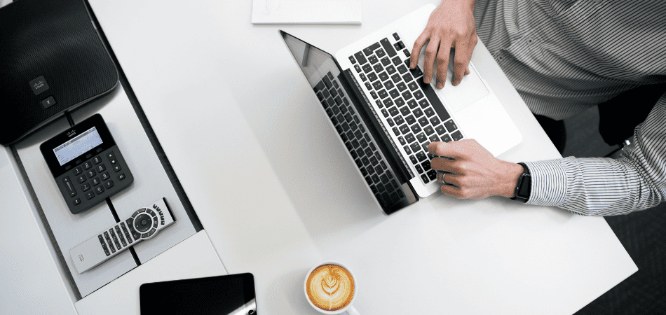 Man sitting at a desk, using his computer